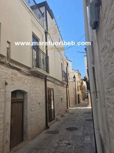 an alley in an old town with buildings at MARE FUORI LUXURY B&b in Cassano delle Murge