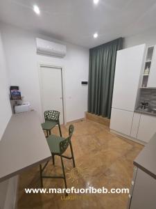a living room with a table and chairs in a room at MARE FUORI LUXURY B&b in Cassano delle Murge