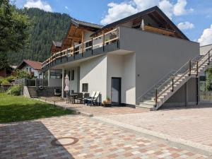 a house with a balcony and a patio at Appart Gfall in Ried im Oberinntal