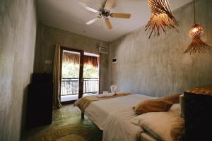 a bedroom with two beds and a ceiling fan at Casa Felipe in General Luna