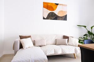 a living room with a couch and a painting at La casina - YourPlace Abruzzo in Fossacesia