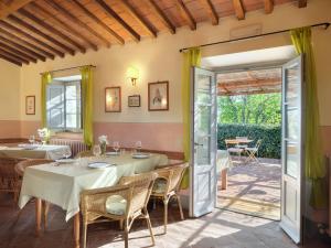 a restaurant with tables and chairs and a patio at La Locanda Volpaia in Radda in Chianti
