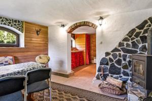 a bedroom with a bed and a fireplace in a room at Chlúpka u Luisa in Telgárt