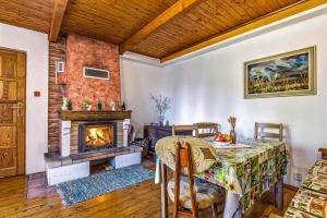 a dining room with a table and a fireplace at Chlúpka u Luisa in Telgárt