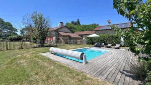 a swimming pool with a bench next to a house at Lascaux in Saint-Mathieu