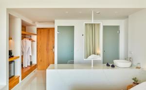a bathroom with a white tub and a sink at Hara Ilios Village in Gouves +83 photos