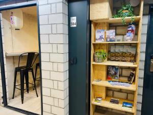 a door into a book shelf with books at Peaky Riders Self Check-in Hotel in Zermatt