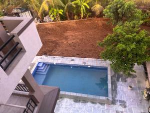 an overhead view of a swimming pool in a yard at Vasant Vihar Farm House in Silvassa +5 photos