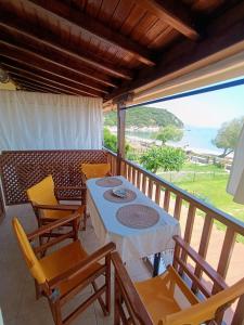 a table and chairs on a balcony with a view of the ocean at XD Al Mare in Ierissos