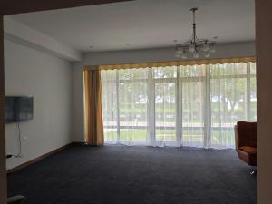 a living room with large windows and a television at Вилла Витязь in Chok-Tal