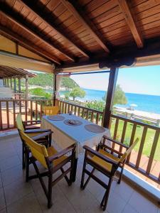 a dining room with a table and chairs and the ocean at XD Al Mare in Ierissos