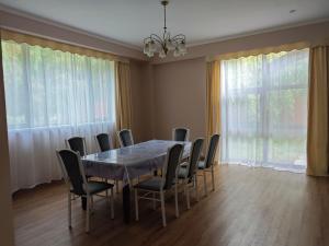 a dining room with a table and chairs at Вилла Витязь in Chok-Tal +12 photos
