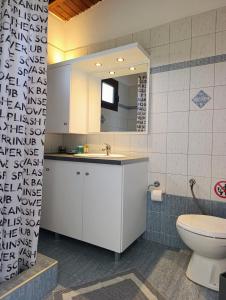 a bathroom with a white sink and a toilet at XD Al Mare in Ierissos +95 photos