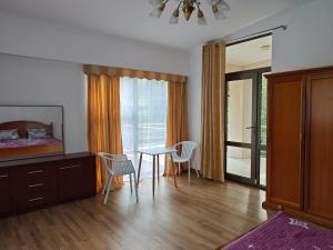 a room with a table and chairs and a bedroom at Вилла Витязь in Chok-Tal
