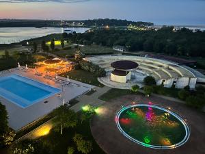 an overhead view of a swimming pool at night at Studio Cris Sea View in Blaxy Residence in Douăzeci şi Trei August