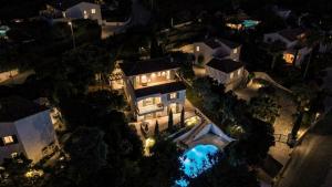 an aerial view of a mansion at night at Villa JuliMée in Les Issambres
