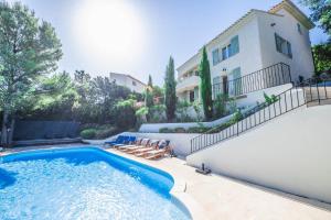 a villa with a swimming pool and a house at Villa JuliMée in Les Issambres