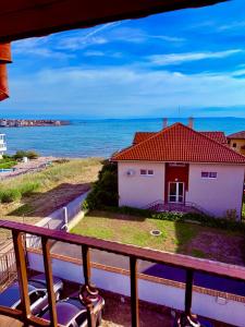 a house with a red roof and the ocean at Хотел Свети Димитър in Sozopol +23 photos