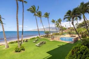 an aerial view of a resort with palm trees and a swimming pool at Kihei Beach Resort 608 in Kihei