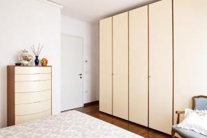 a bedroom with white cabinets and a bed at Condominio Maria Ida in Caorle
