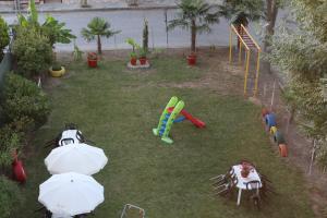 a backyard with a playground with umbrellas and a slide at Iris by Dias in Olympic Beach +13 photos