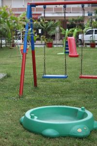 a playground with swings and a play implement at Iris by Dias in Olympic Beach