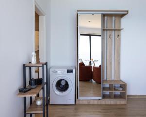 a washing machine in a room with a mirror at Oceanfront Oasis in Borsh