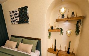 a bedroom with a bed and a mirror on the wall at Hôtel de la Couronne in Les Bois
