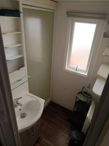 a bathroom with a sink and a window at Le Deauville in Le Grau-dʼAgde +22 photos