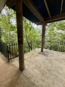 a screened in porch with a fence and trees at Sunlee Aviana in Bandarawela