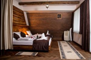 a bedroom with a bed and a wooden wall at Hotel Babino Brdo in Derventa +126 photos