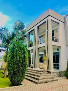 a house with a large bush in front of it at Gravity Villa Musanze in Ruhengeri