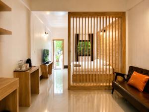 a living room with a bed and a couch at กัลยา รีสอร์ท in Ban Bang Saen (1) +53 photos