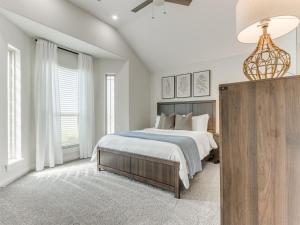 a white bedroom with a large bed and windows at Spacious Modern Comfort Fabulous 15th! in Moore