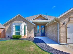 a brick house with a white garage at Spacious Modern Comfort Fabulous 15th! in Moore