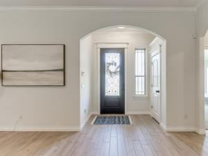 an empty hallway with a door and a window at Spacious Modern Comfort Fabulous 15th! in Moore +27 photos
