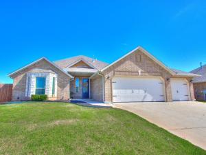 a large brick house with a garage at Spacious Modern Comfort Fabulous 15th! in Moore