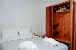 a bedroom with a bed with two towels on it at LV Luxury Apartment in Parga