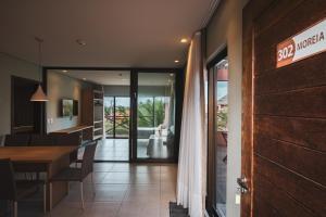 a dining room with a table and a door at Villas BobZ in Barrinha