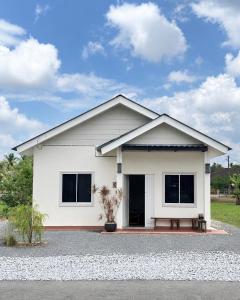 a white house with a lot of windows at Deyrina Home in Arau