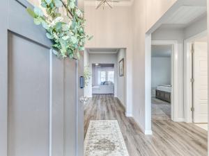 a hallway with a door with a plant on it at Kingsport Modern Oasis in Broken Arrow
