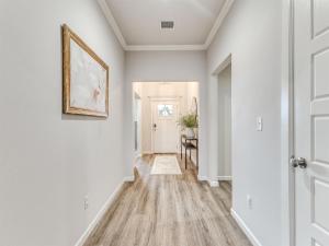 a hallway of a home with white walls at Kingsport Modern Oasis in Broken Arrow
