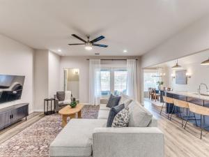 a living room with a couch and a table at Kingsport Modern Oasis in Broken Arrow