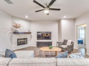 a living room with a couch and a fireplace at Kingsport Modern Oasis in Broken Arrow +17 photos
