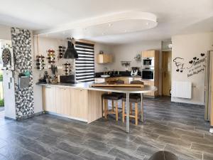 a kitchen with a table and a refrigerator at ti ar maez in Mauron