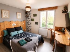a bedroom with a bed and a window at ti ar maez in Mauron