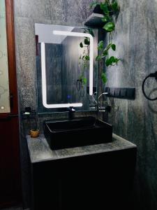 a bathroom with a black sink and a mirror at S & B Villa Weligama in Weligama