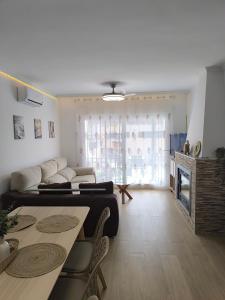 a living room with a couch and a table at Casa Torrox Costa cerca del mar in Torrox