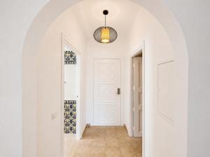 a hallway with a white door and a pendant light at Le Corail Apart'Hotel & Splash Park in Hammamet +71 photos