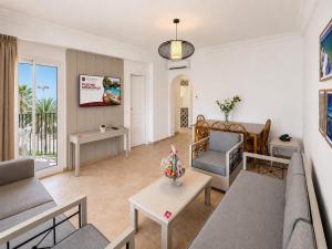 a living room with a couch and a table at Le Corail Apart'Hotel & Splash Park in Hammamet